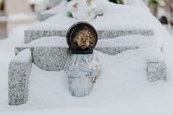 A Glass Bottle on Snow Covered Ground