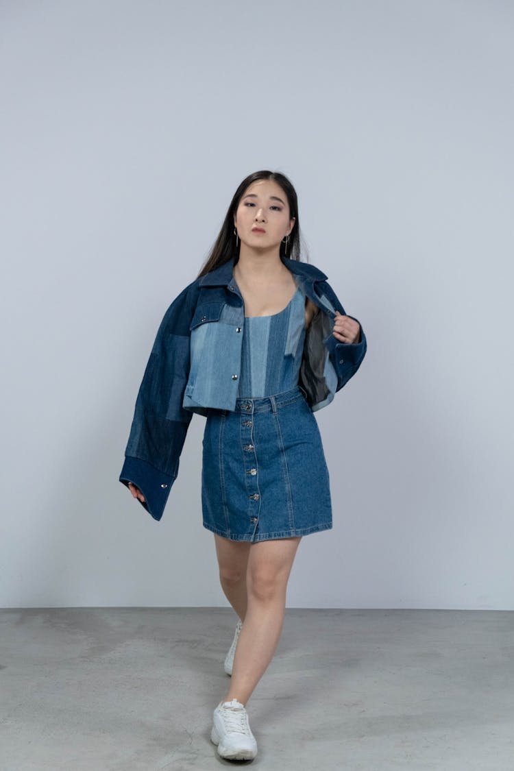 A Woman Wearing Denim Jacket And Denim Skirt