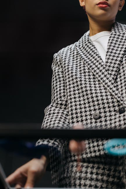 A fashionable woman in a houndstooth plaid blazer
