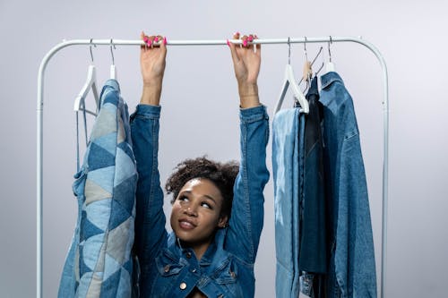 Woman in Denim Jacket Hanging on Clothing Rack
