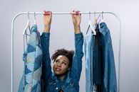 Boy in Blue Denim Jacket Holding Clothes Hanger