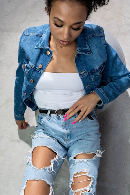Top View of a Woman in Denim Jacket and Ripped Jeans