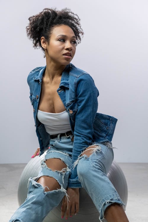 Black Wearing A Denim Vest And Jeans With No Bra. Stock Photo