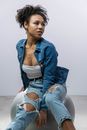 Woman in Blue Denim Jacket and White Crop Top