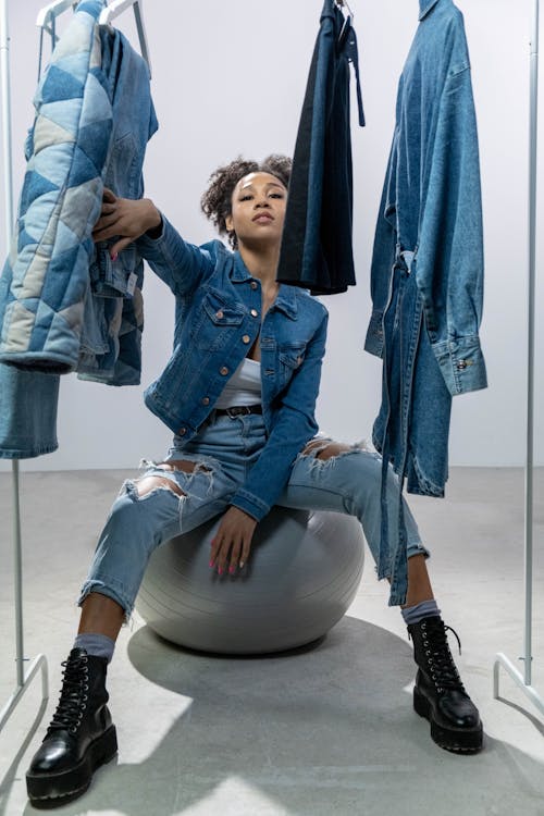 Woman Posing near Clothes Hanger