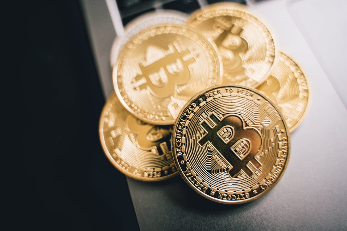 Free A Close-up Shot of Gold Bitcoins on Gray Surface  Stock Photo