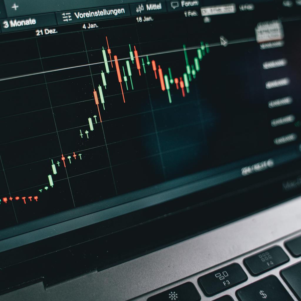 Laptop screen displaying a stock market chart.