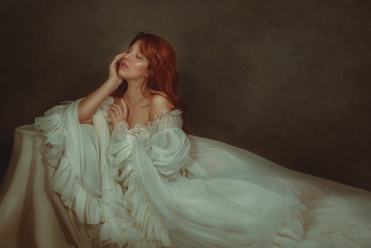 Woman In White Off Shoulder Dress With Red Hair