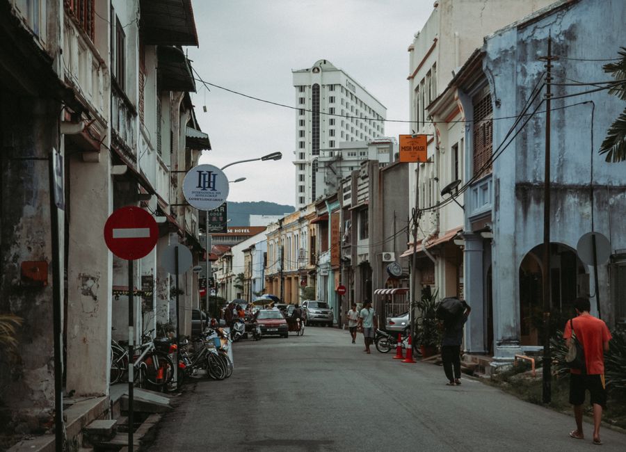 Explore a lively, narrow street filled with historic charm, showcasing urban life and people.