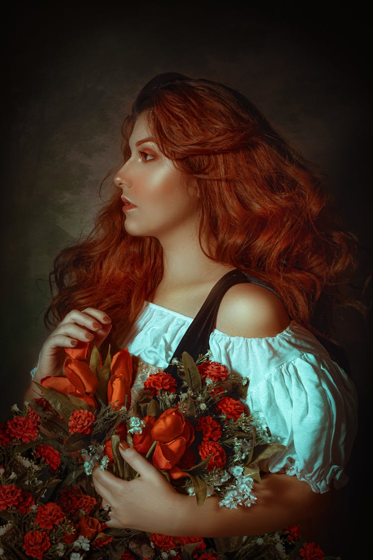 Beautiful Woman With Red Hair Holding Orange Flowers