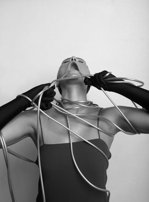 Black and White Photo of a Woman Eating the Ropes