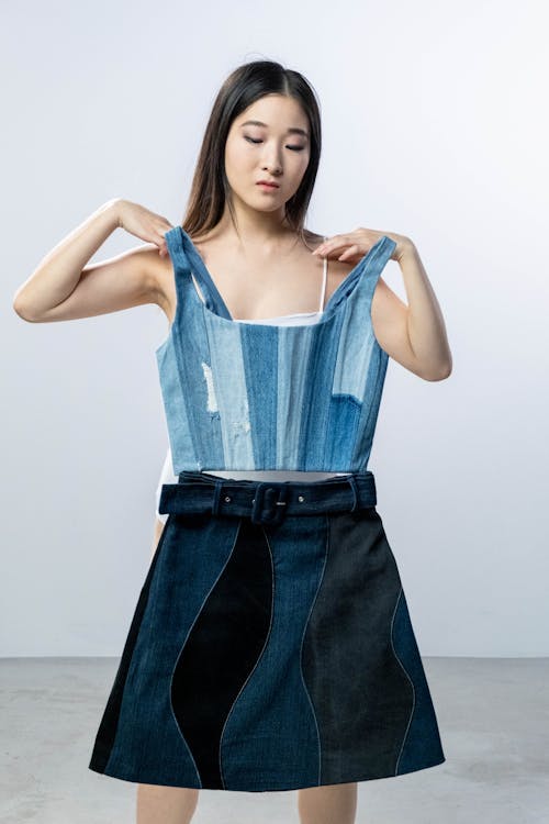Free Woman in Blue Sleeveless Top and Black Denim Skirt Stock Photo