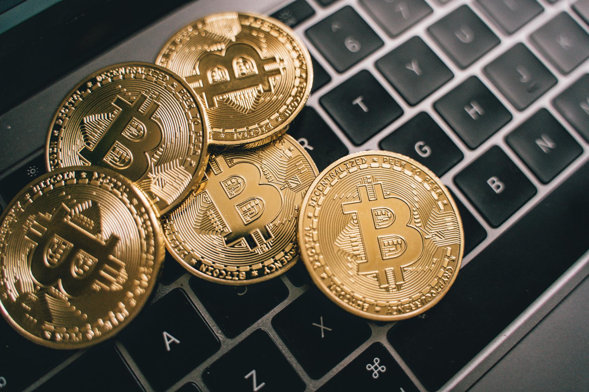 A Close-up shot of Bitcoins on a Laptop Keyboard