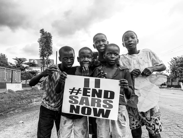 Group Of Boys Holding End SARS Sign Against Police Brutality