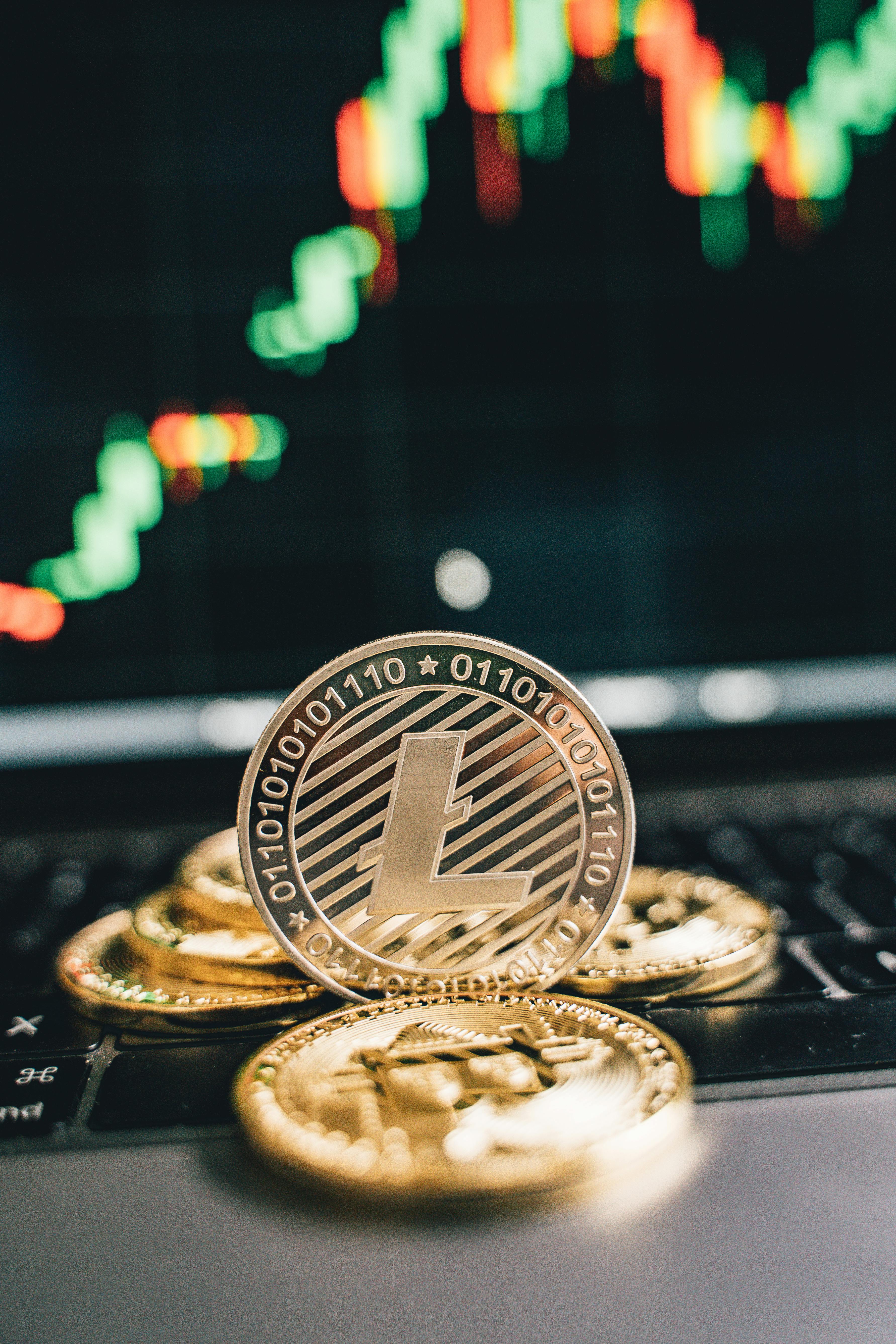 gold round coin on black surface