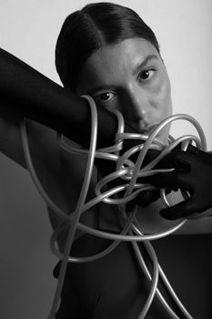 Moody grayscale portrait of a woman entwined with rope suggesting conceptual tension.