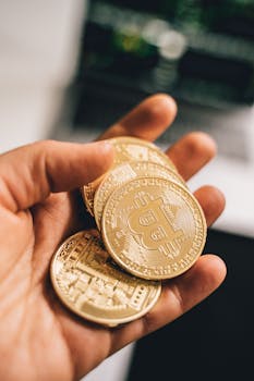 Close-up of a hand holding multiple Bitcoin coins symbolizing digital currency and economic growth.