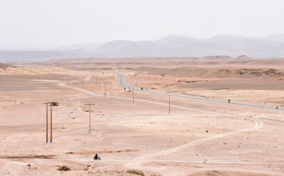 A Person Riding a Motorbike on Desert