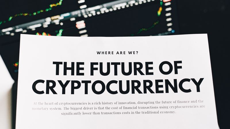 Close-up of a finance article on cryptocurrency with charts in the background.