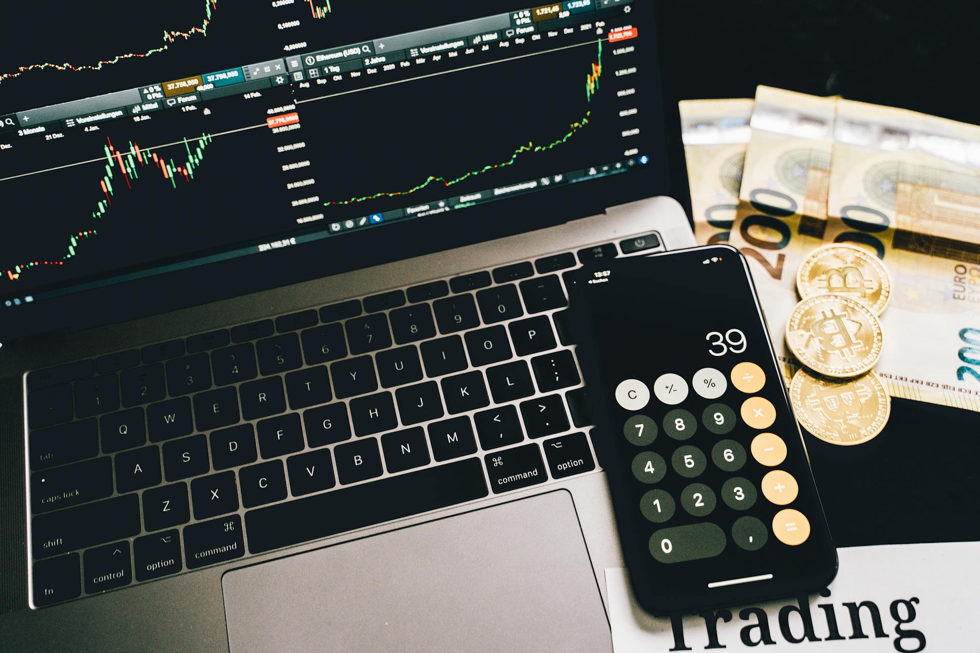 Laptop, Calculator and Money on Desk