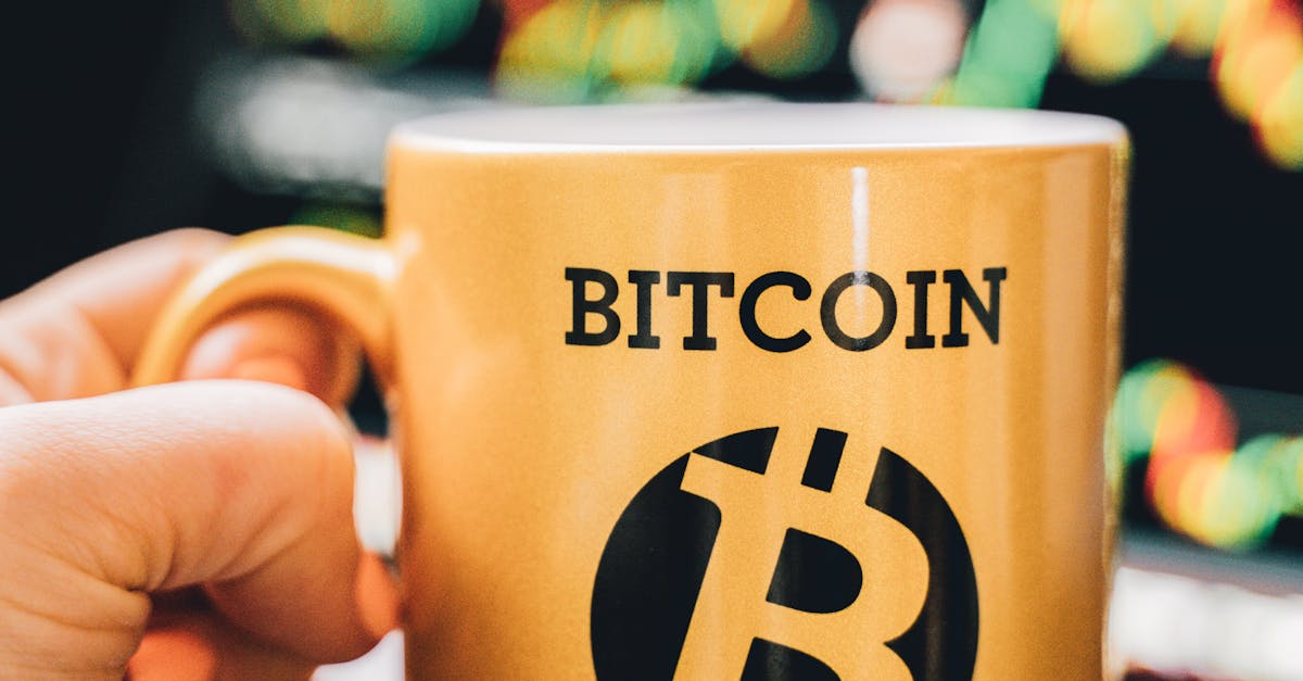 Close-up of a Bitcoin Millionaire mug held in front of a trading screen, emphasizing cryptocurrency success.