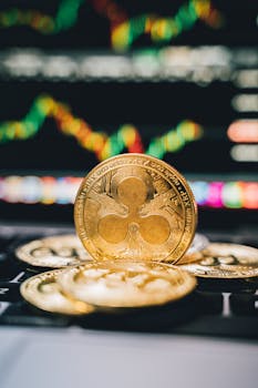 Gold Ripple coins on a laptop with a financial chart background, symbolizing digital currency trends.