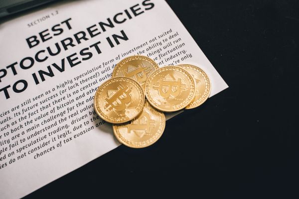 Bitcoin coins resting on an investment document, representing cryptocurrency