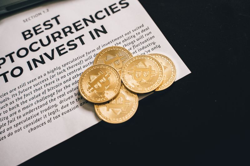 Bitcoin coins resting on an investment document, representing cryptocurrency