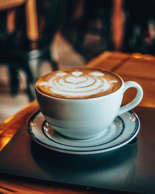Free Warm cappuccino with heart-shaped latte art in a cozy cafe setting in San Luis Potosí. Stock Photo