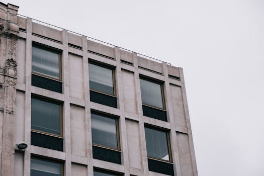 Close-up view of a modern building facade featuring geometric design and glass windows.