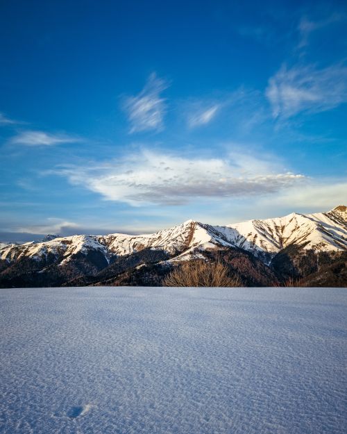 Free Spectacular view of snow-capped mountains under a clear blue sky, showcasing winter beauty. Stock Photo