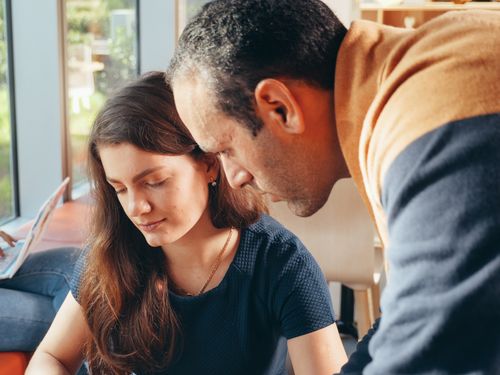 Free Two professionals engaged in a collaborative business discussion inside a well-lit office. Stock Photo