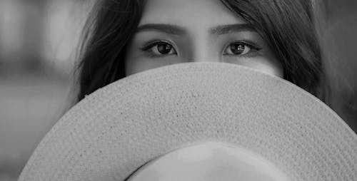 Free Grayscale Photography of Woman Covering Her Face With Sun Hat Stock Photo