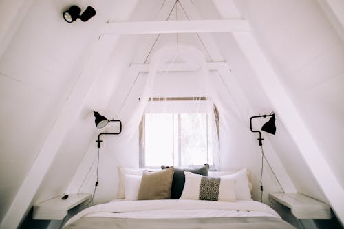 Free Pillows on a Bed in a Bedroom in the Attic Stock Photo