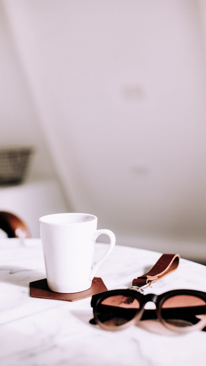 Leather coasters arranged on a coffee and tea bar counter under a steaming mug