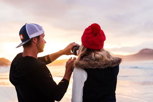 A Couple Taking a Picture on a Beach