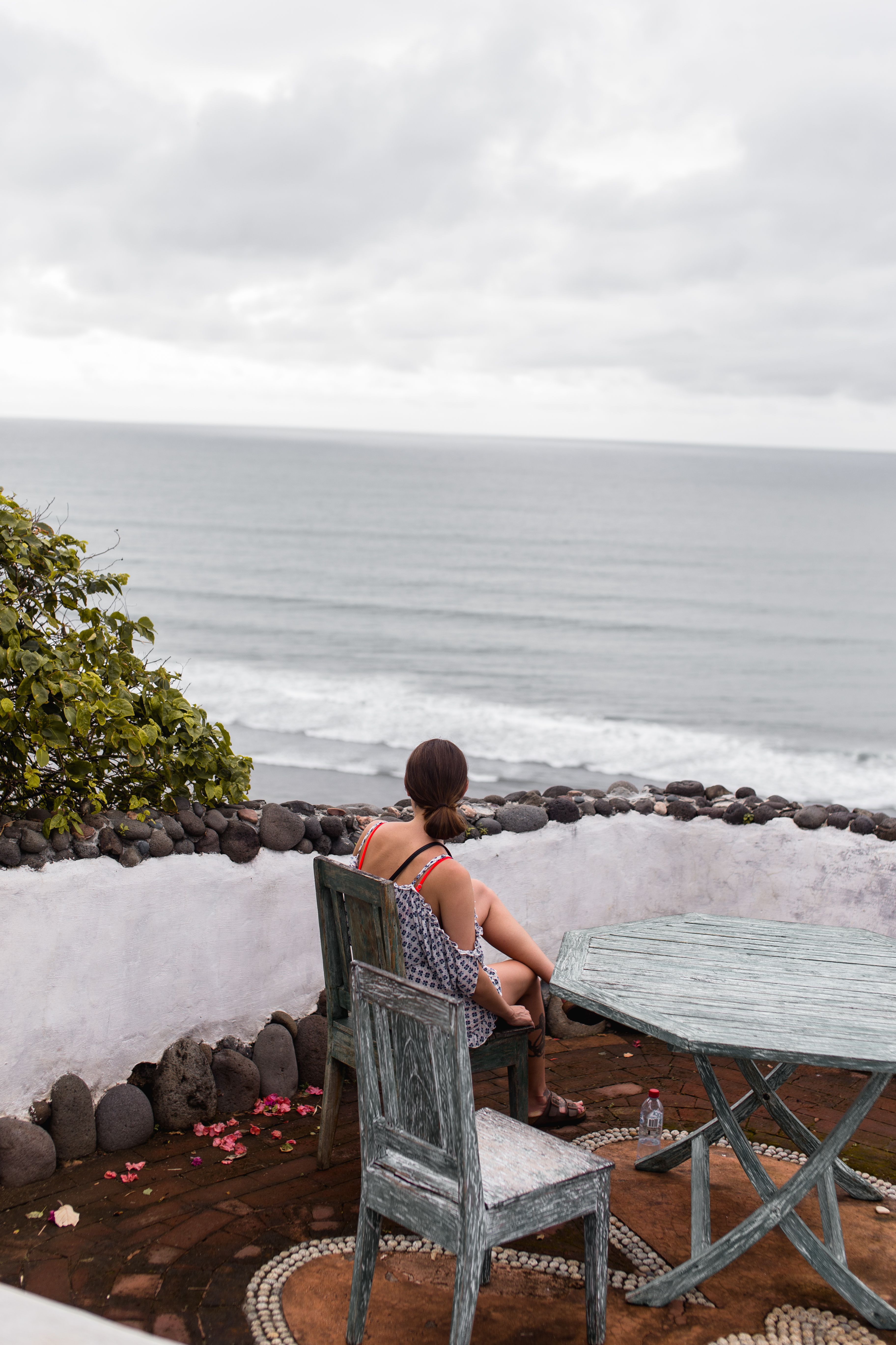 Woman Sitting near Sea Shore · Free Stock Photo