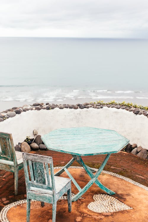 Wooden Chairs and Table on Seashore