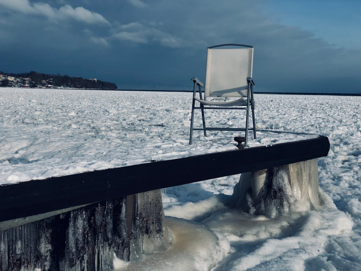 Person holding a smartphone in front of a city skyline at dusk, symbolizing social media announcements