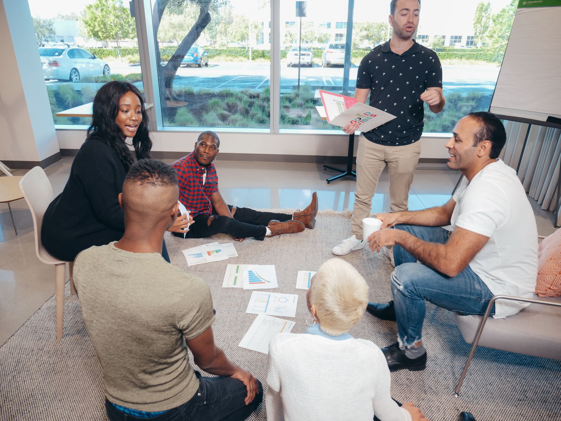 A diverse team collaborating on a project with documents in a modern office setting.