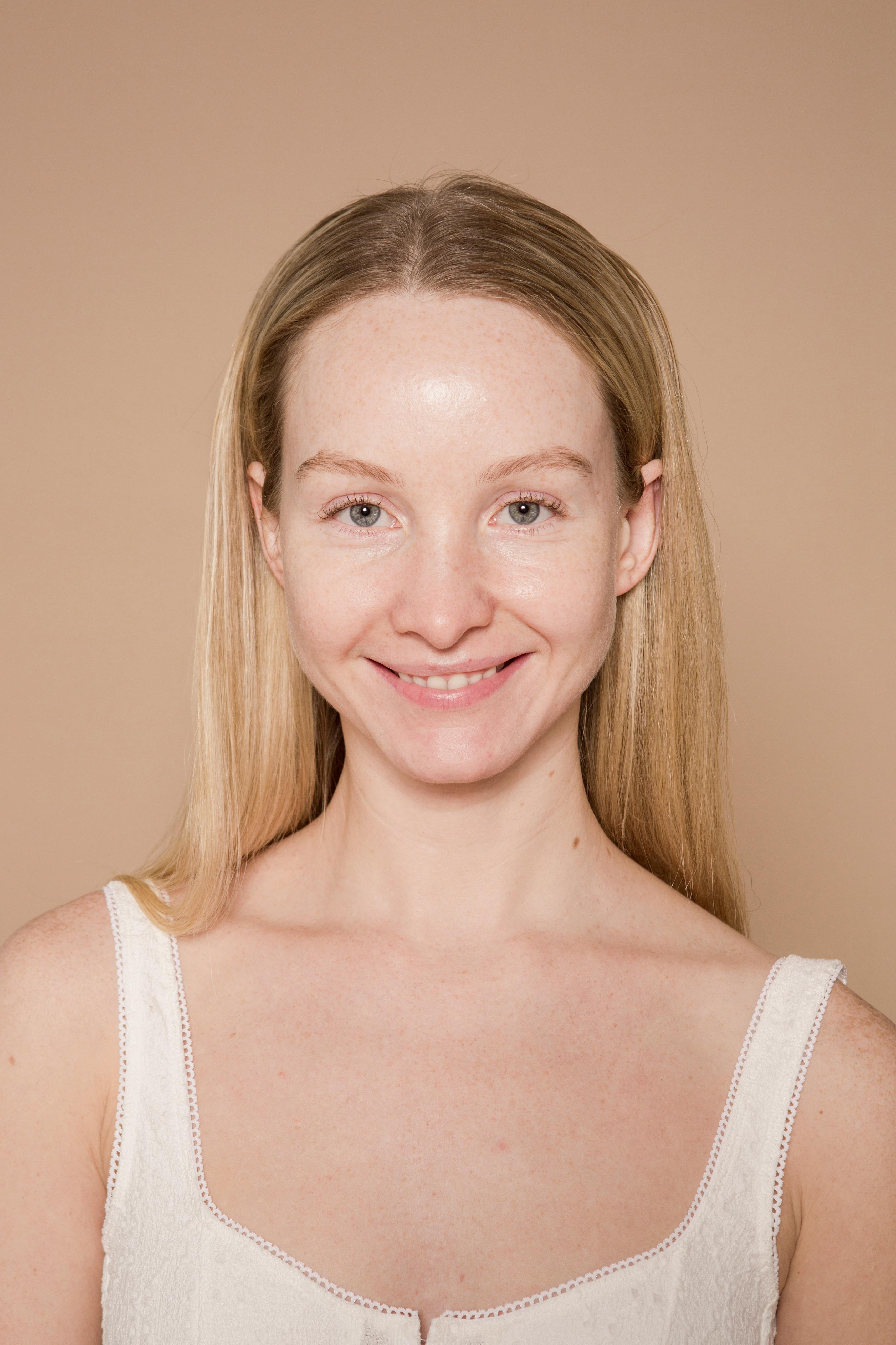 positive female looking at camera against beige background