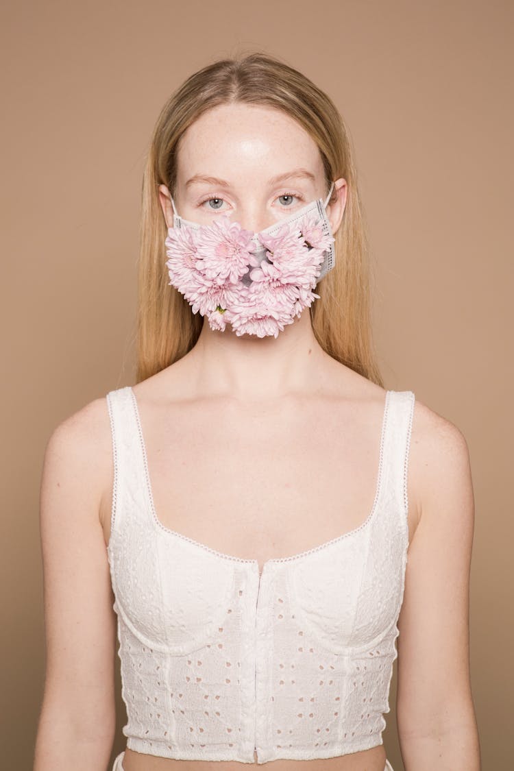 Calm Woman In White Apparel And Flower Mask