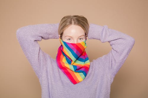 Woman with bright rainbow facial scarf