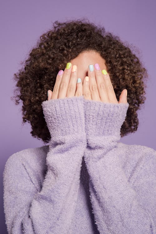 Free Shy woman covering face with hands Stock Photo