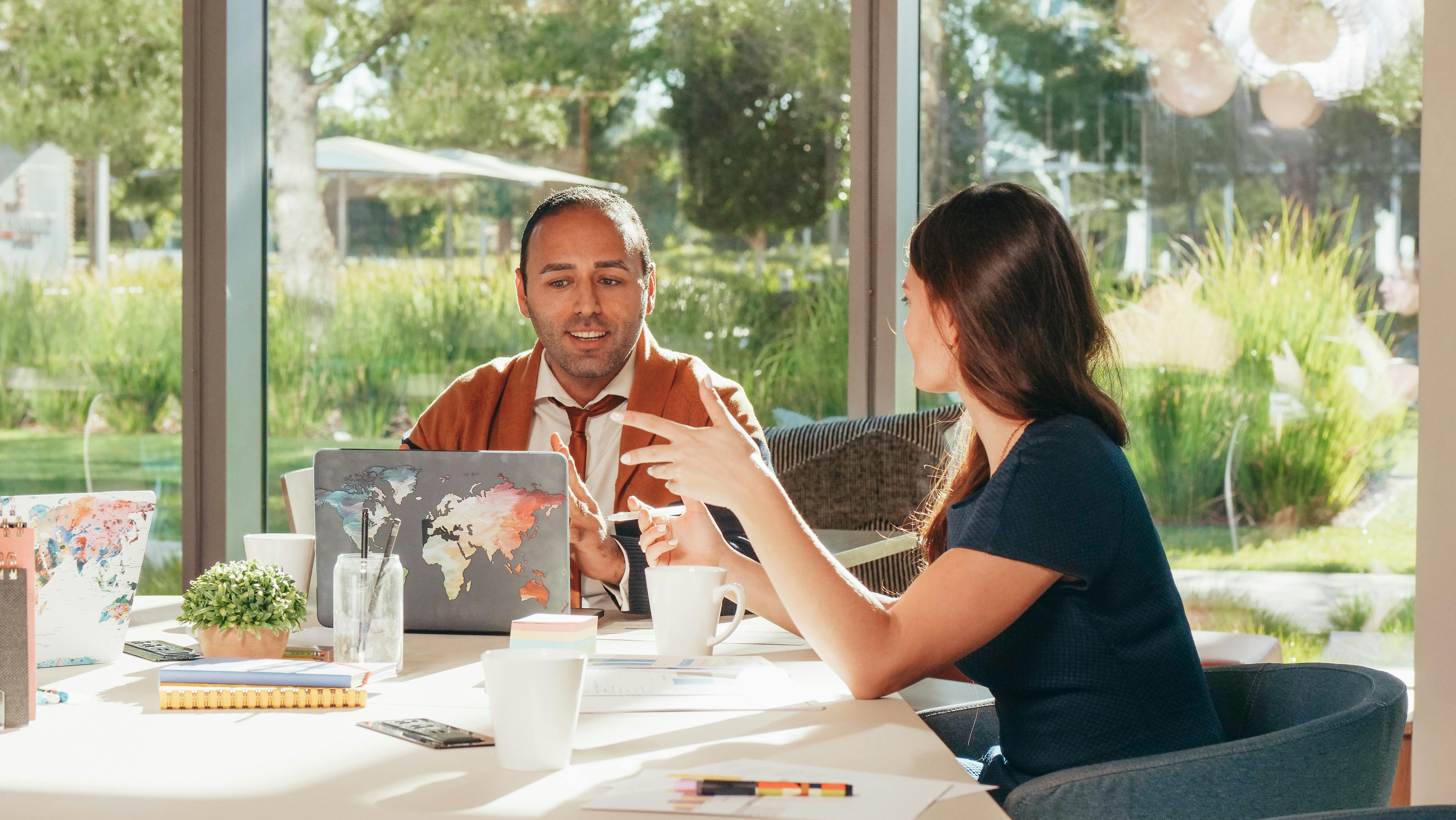 Business professionals discussing strategy in a bright, modern office setting.