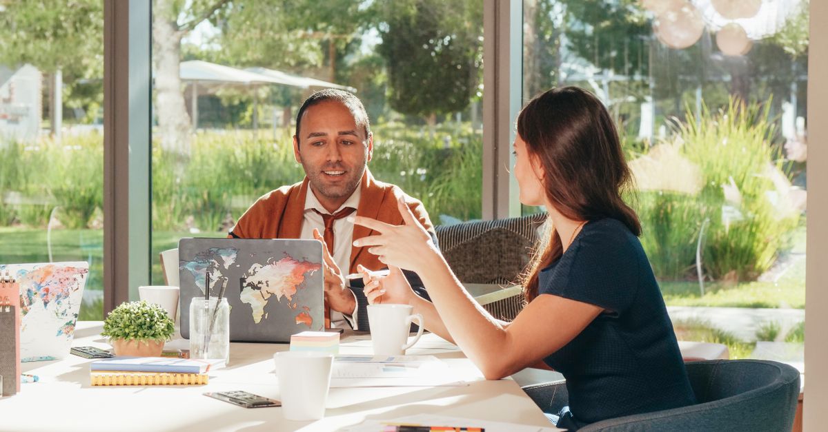 Business professionals discussing strategy in a bright, modern office setting.