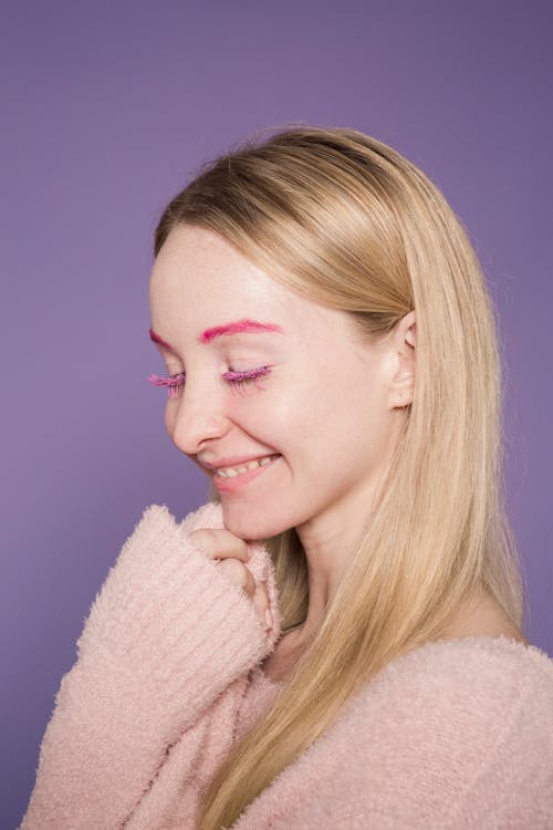 Free Cheerful woman with unusual pink eyebrows Stock Photo