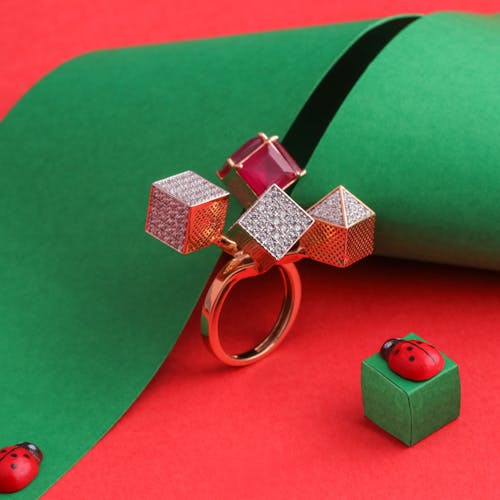 Close-Up Shot of a Diamond Ring on a Red Surface