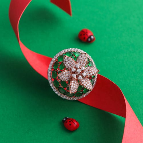 Close-Up Shot of a Diamond Ring on a Green Surface