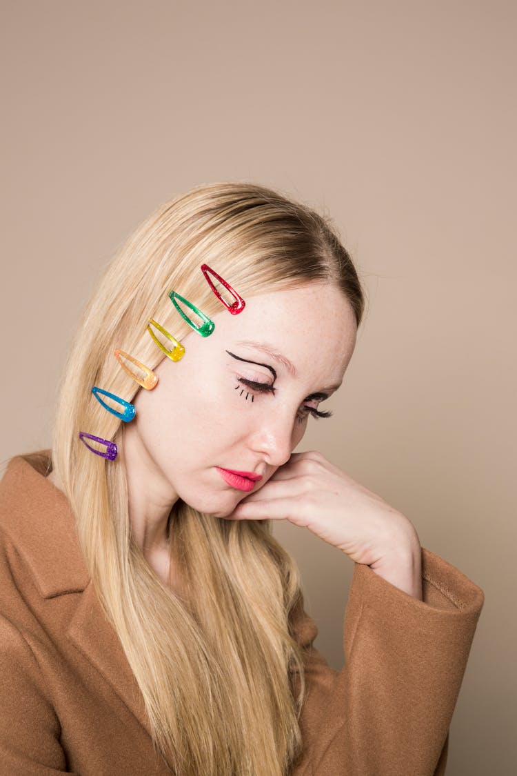 Sad Woman With Bright Hair Clips On Head